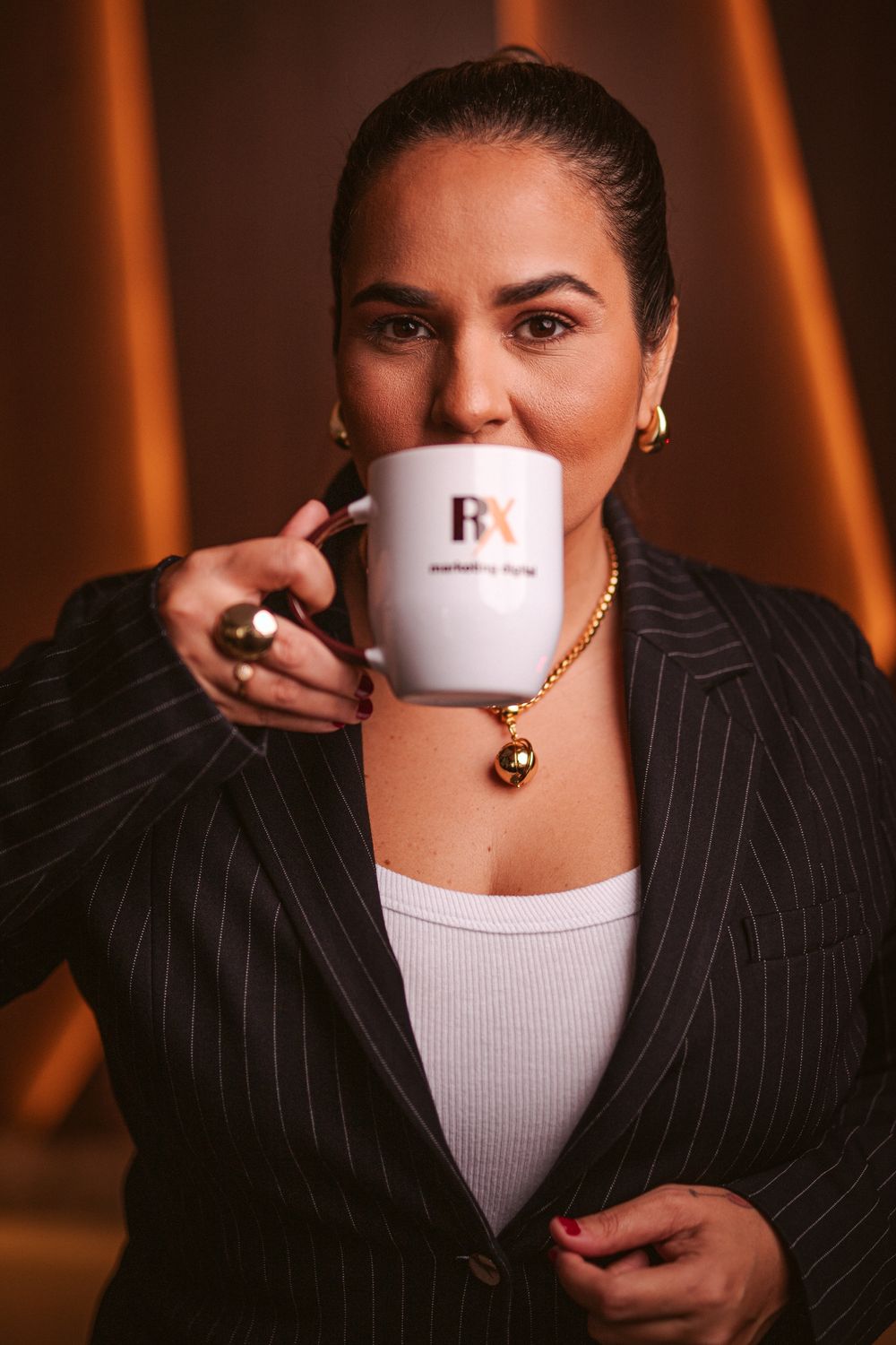 Roxane Plácido tomando café em caneca da RX Marketing Digital